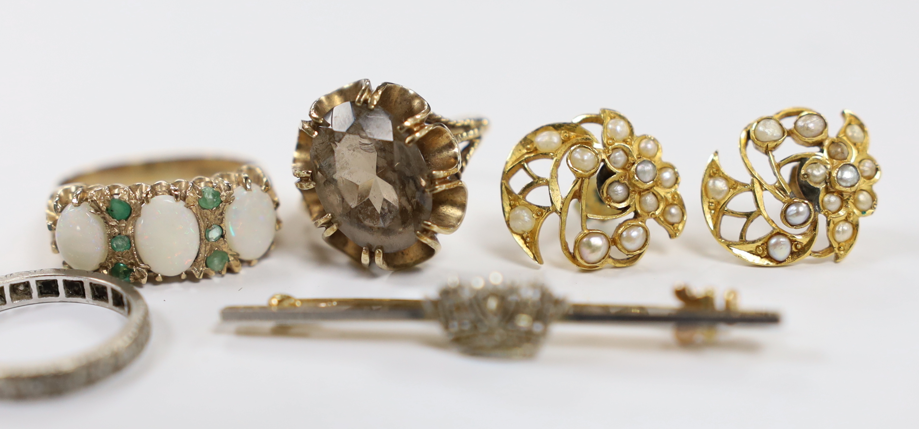 Assorted jewellery including a modern pair of 14k and blue topaz earrings, a pair of 375 and seed pearl cluster earrings, two 9ct gold and gem set rings including a white opal and emerald chip, a white metal and diamond